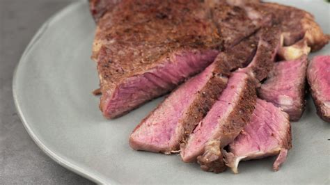 cooking rare steak on grill